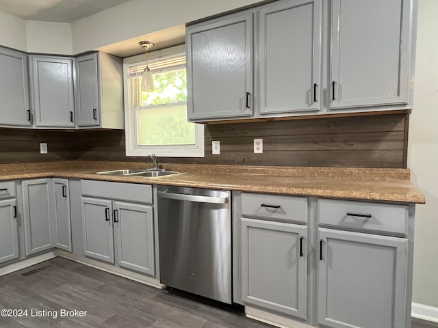 kitchen with stainless steel dishwasher, dark hardwood / wood-style flooring, and gray cabinets