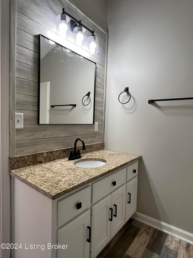 bathroom with vanity and hardwood / wood-style flooring