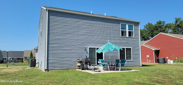 rear view of house featuring a lawn, a patio area, and central AC