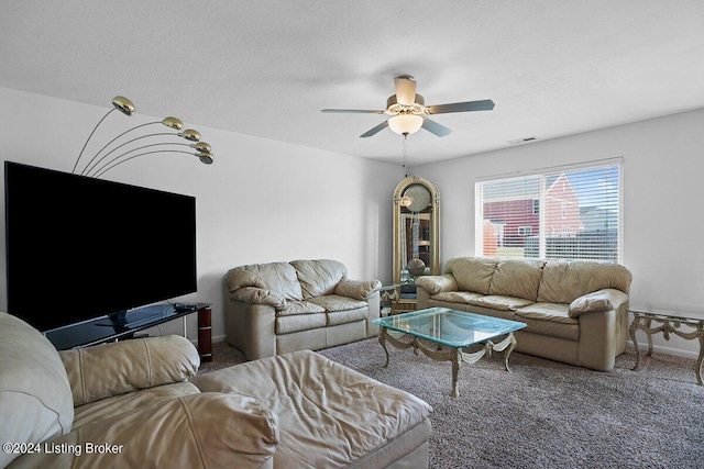 carpeted living room with a textured ceiling and ceiling fan