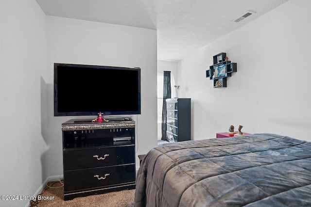 carpeted bedroom with a textured ceiling