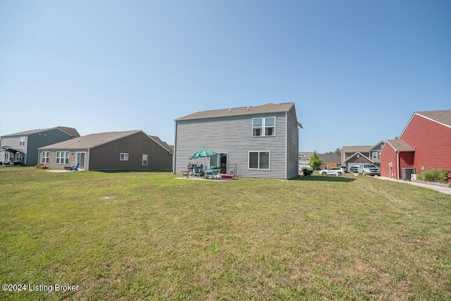 back of house with a yard and a patio area