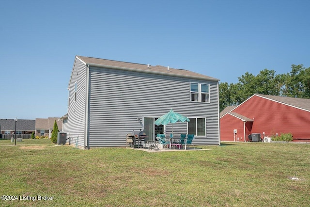 back of property with a patio, a lawn, and central AC unit