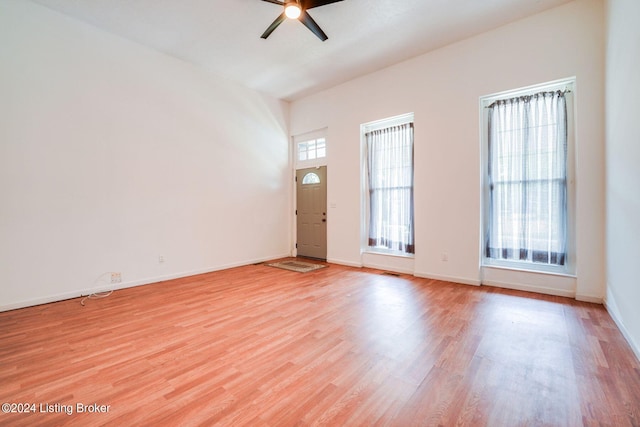 spare room with light wood-type flooring and ceiling fan