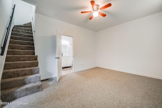 interior space featuring ceiling fan and carpet floors