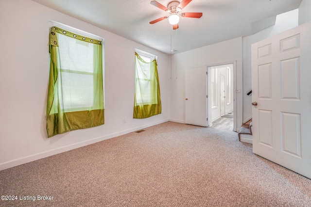 empty room with light carpet and ceiling fan