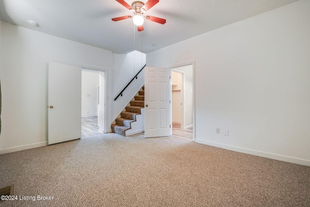 carpeted empty room featuring ceiling fan