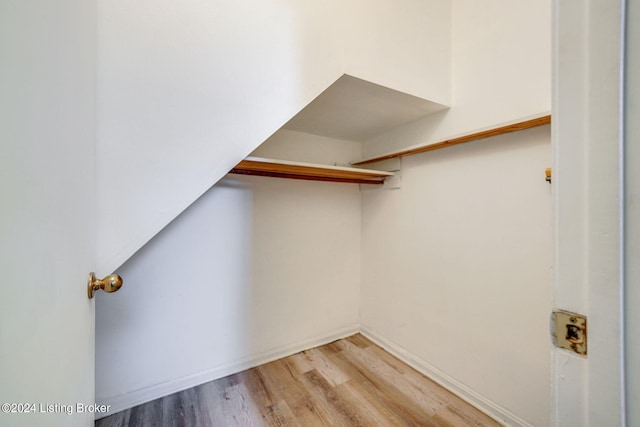 spacious closet featuring light hardwood / wood-style flooring