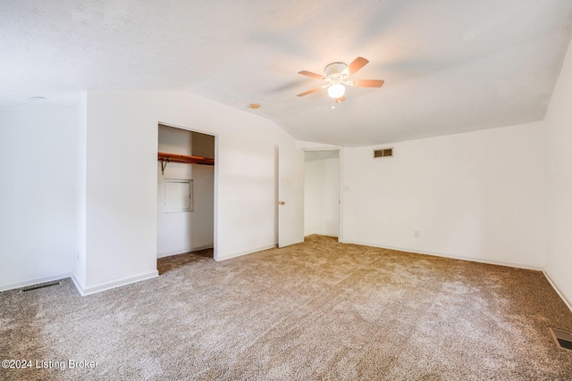 unfurnished bedroom featuring ceiling fan, light carpet, and vaulted ceiling