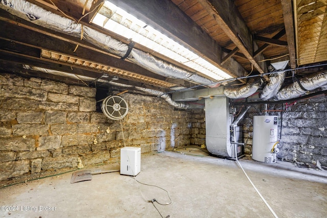 basement featuring gas water heater and heating unit