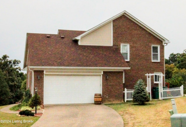 view of front of house with a garage and a front lawn