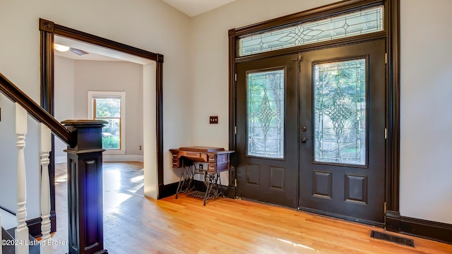 entryway with wood-type flooring and french doors