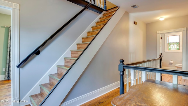 staircase featuring hardwood / wood-style flooring