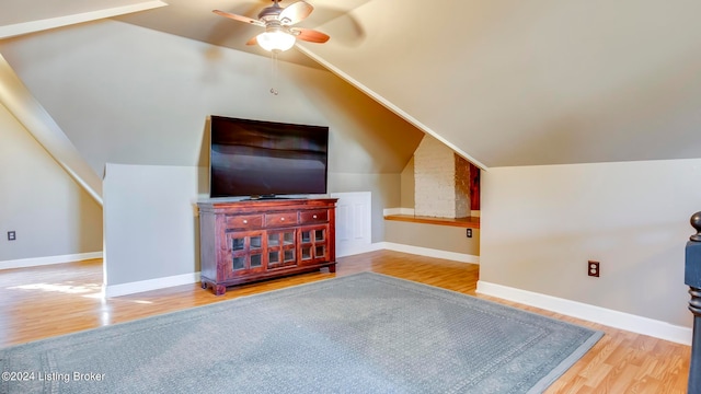 bonus room with wood-type flooring, vaulted ceiling, and ceiling fan