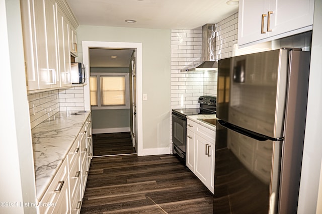 kitchen with white cabinets, wall chimney exhaust hood, light stone countertops, dark hardwood / wood-style flooring, and stainless steel appliances