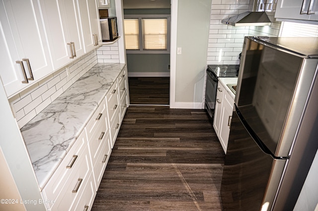 kitchen with electric range, tasteful backsplash, dark hardwood / wood-style flooring, stainless steel fridge, and white cabinets