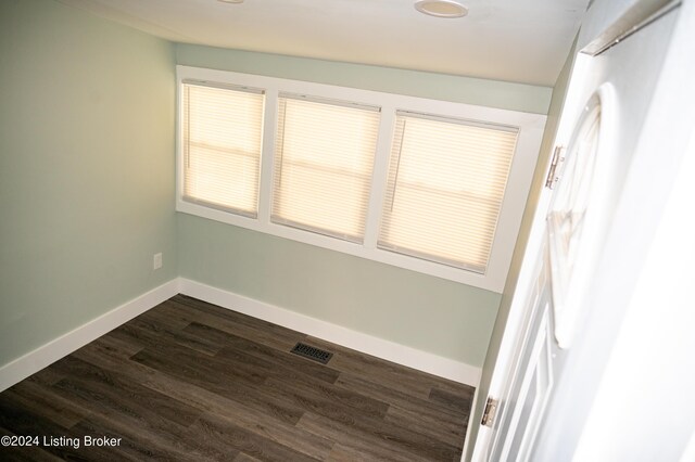 unfurnished room with dark hardwood / wood-style floors