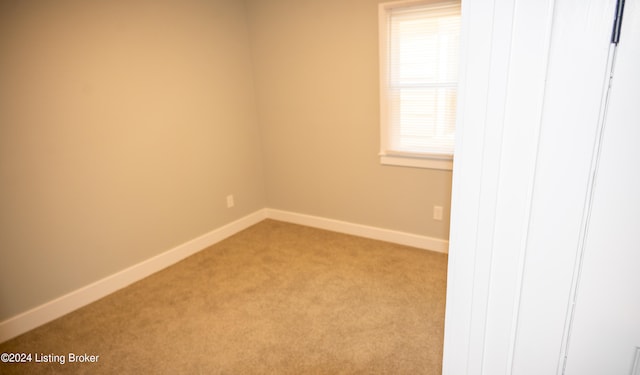 empty room featuring light carpet