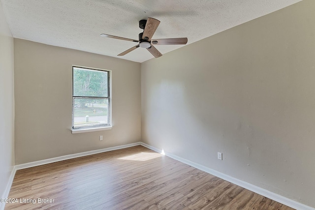 unfurnished room featuring ceiling fan, a textured ceiling, and light wood-type flooring