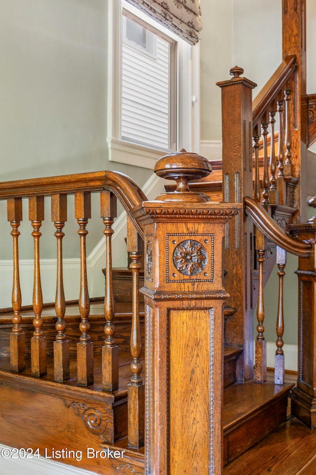 stairs featuring hardwood / wood-style floors