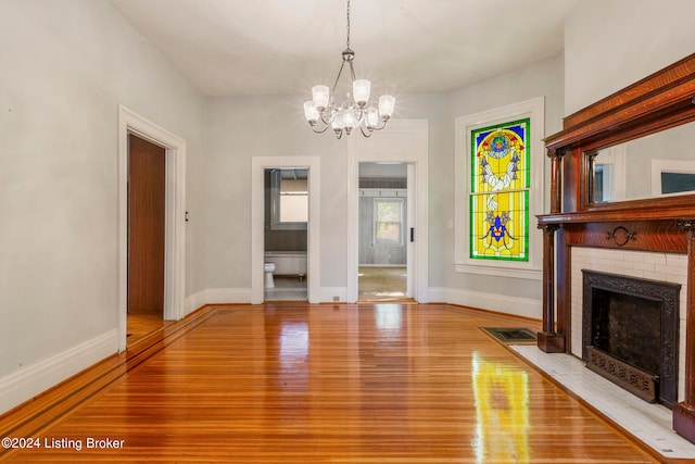 interior space with a chandelier and light hardwood / wood-style flooring