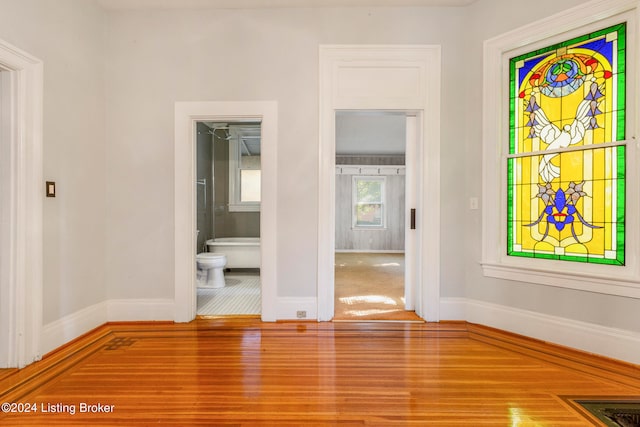 unfurnished room with hardwood / wood-style floors