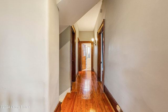 hallway with hardwood / wood-style flooring