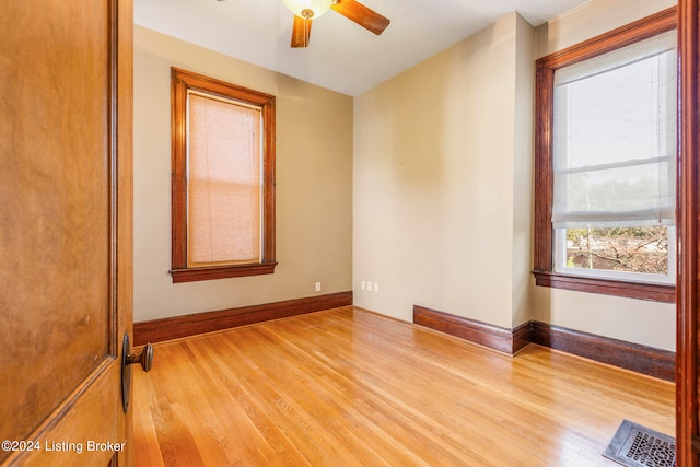 empty room with light wood-type flooring and ceiling fan