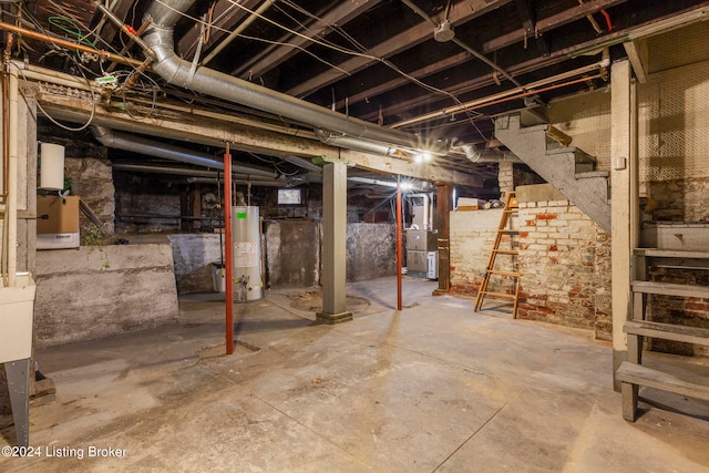 basement featuring gas water heater and heating unit