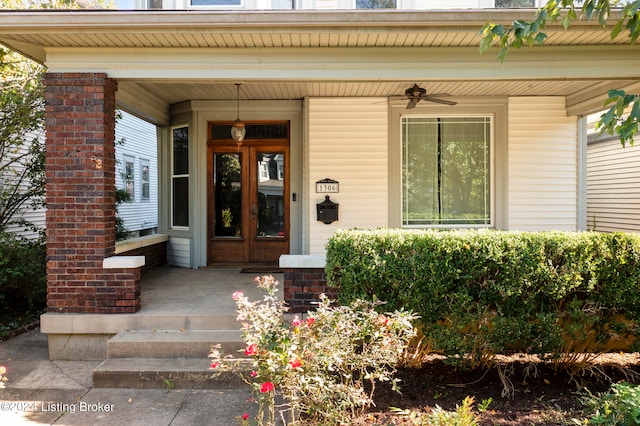 view of exterior entry with covered porch and ceiling fan