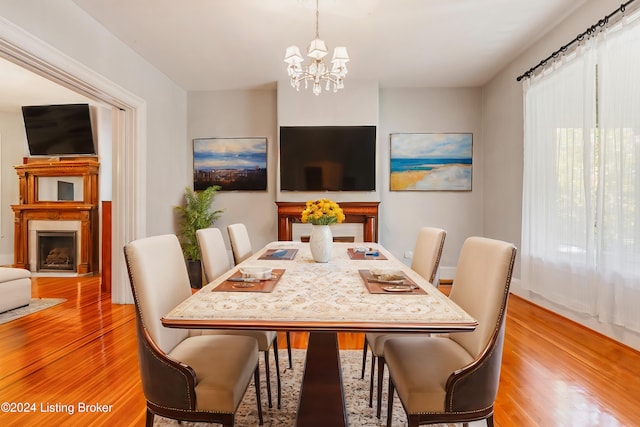 dining space featuring an inviting chandelier and light hardwood / wood-style floors