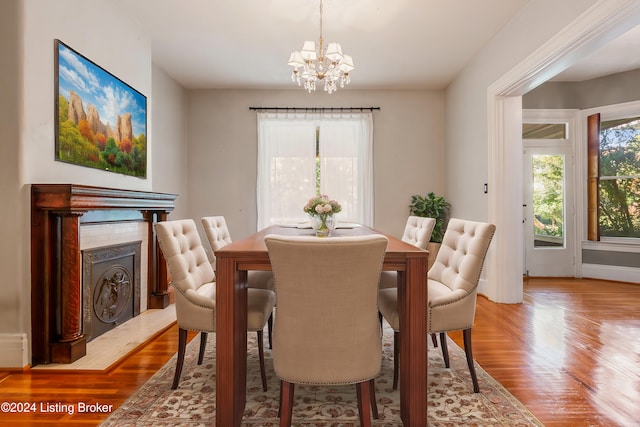 dining room with hardwood / wood-style floors and a chandelier