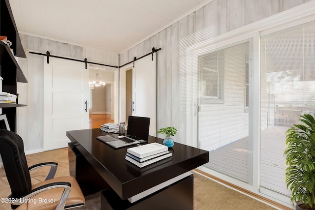 office with ornamental molding, wood walls, and a barn door