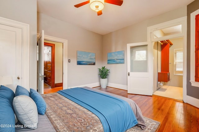 bedroom with ceiling fan, hardwood / wood-style flooring, and ensuite bathroom