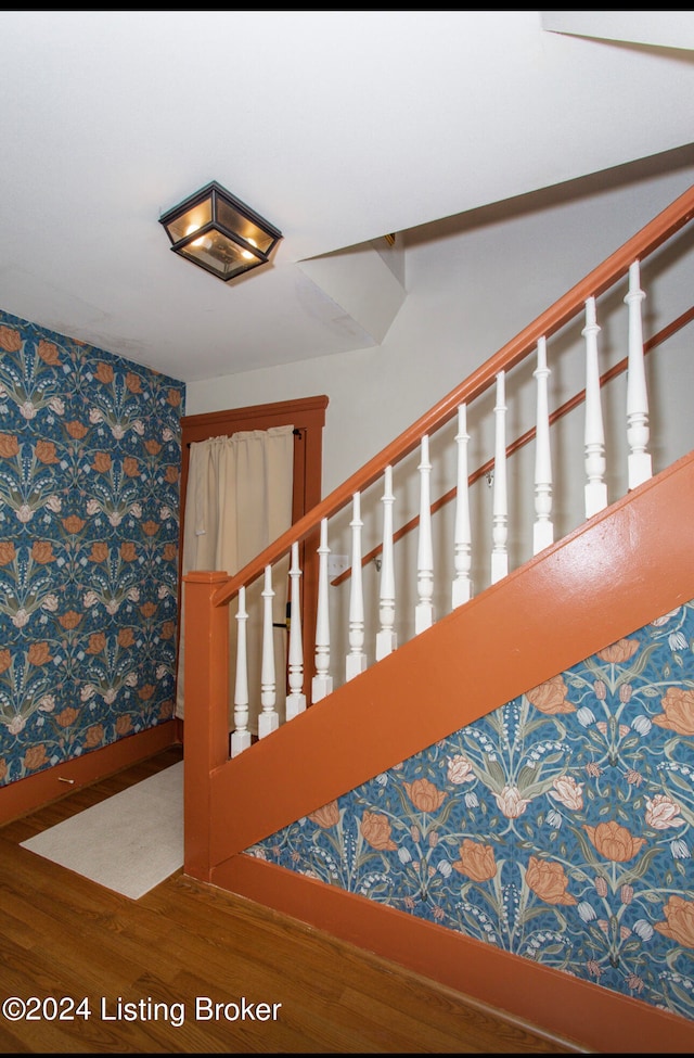 stairs featuring hardwood / wood-style flooring