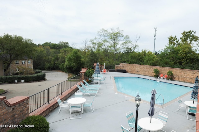 view of swimming pool with a patio