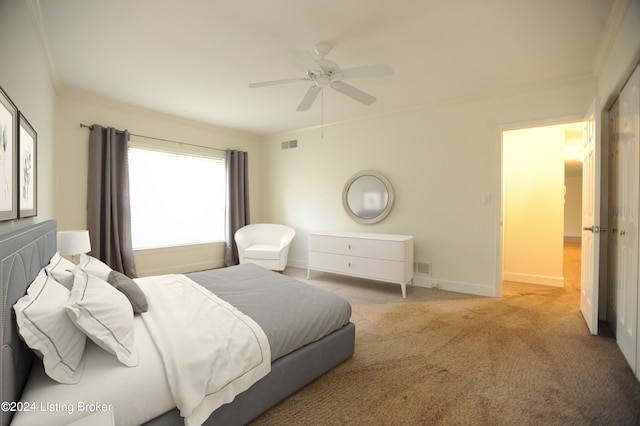 carpeted bedroom featuring ceiling fan and ornamental molding