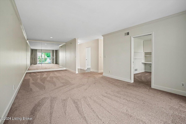 carpeted empty room with crown molding