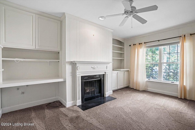 unfurnished living room featuring ornamental molding, ceiling fan, and light colored carpet