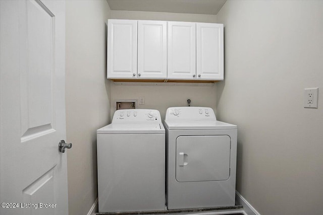 clothes washing area featuring cabinets and independent washer and dryer