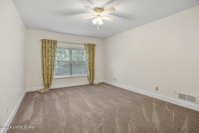 empty room with ceiling fan and carpet flooring