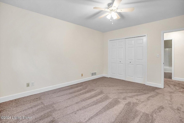 unfurnished bedroom featuring carpet floors, ceiling fan, and a closet