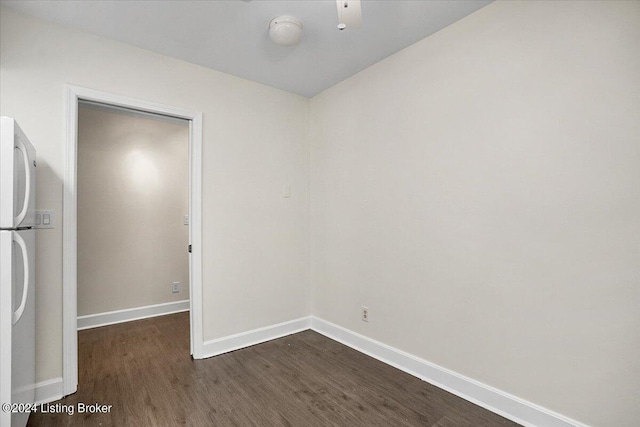 empty room with ceiling fan and dark wood-type flooring