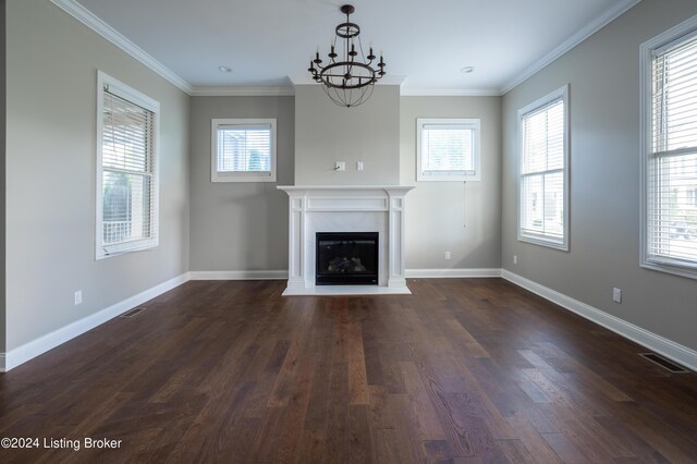 unfurnished living room featuring ornamental molding, an inviting chandelier, and dark hardwood / wood-style flooring