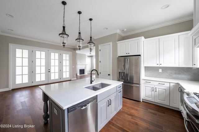 kitchen featuring white cabinets, stainless steel appliances, a center island with sink, dark hardwood / wood-style floors, and sink