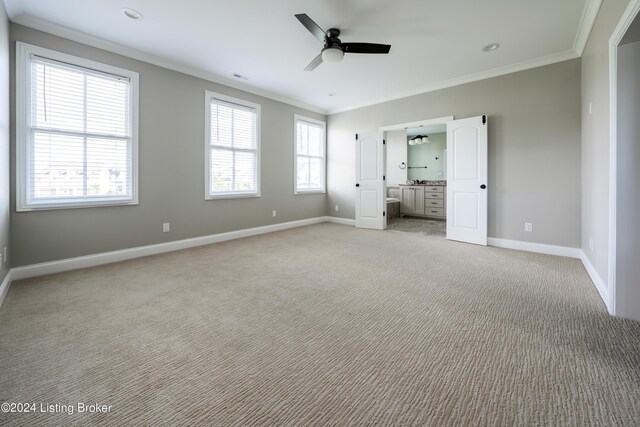 unfurnished bedroom featuring ornamental molding, ceiling fan, and light colored carpet