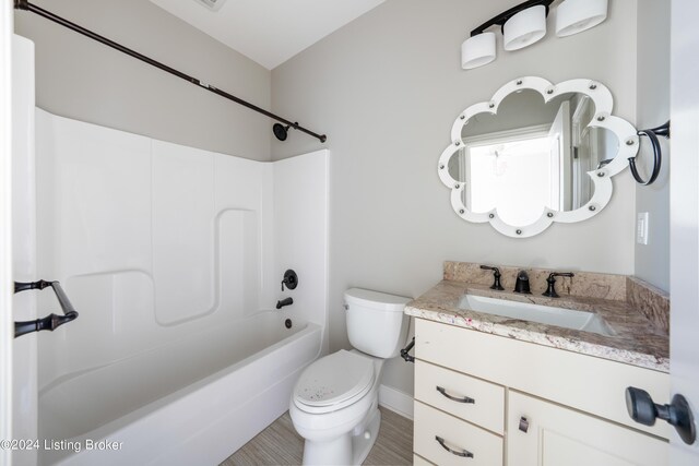 full bathroom featuring  shower combination, vanity, and toilet