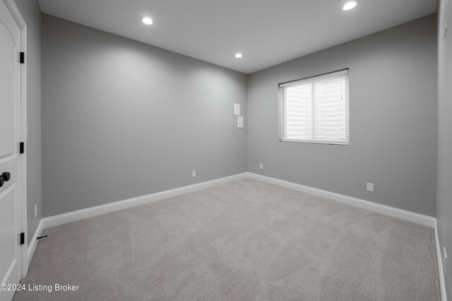 empty room with light colored carpet