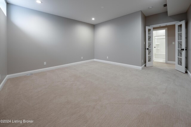 carpeted empty room featuring french doors