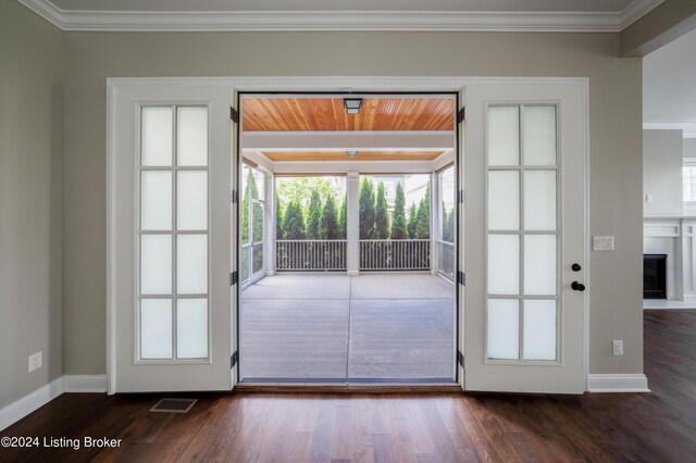 doorway to outside featuring ornamental molding and dark wood-type flooring